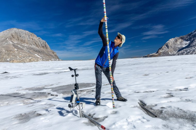 Glaciologist at ETHZ and head of the Glacier Monitoring in Switzerland (GLAMOS) Matthias Huss takes note of the decrease of ice, amid climate change on the Plaine Morte glacier in Crans-Montana, Switzerland, September 5, 2023. REUTERS/Denis Balibouse