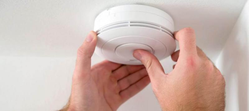 man-installing-smoke-alarm